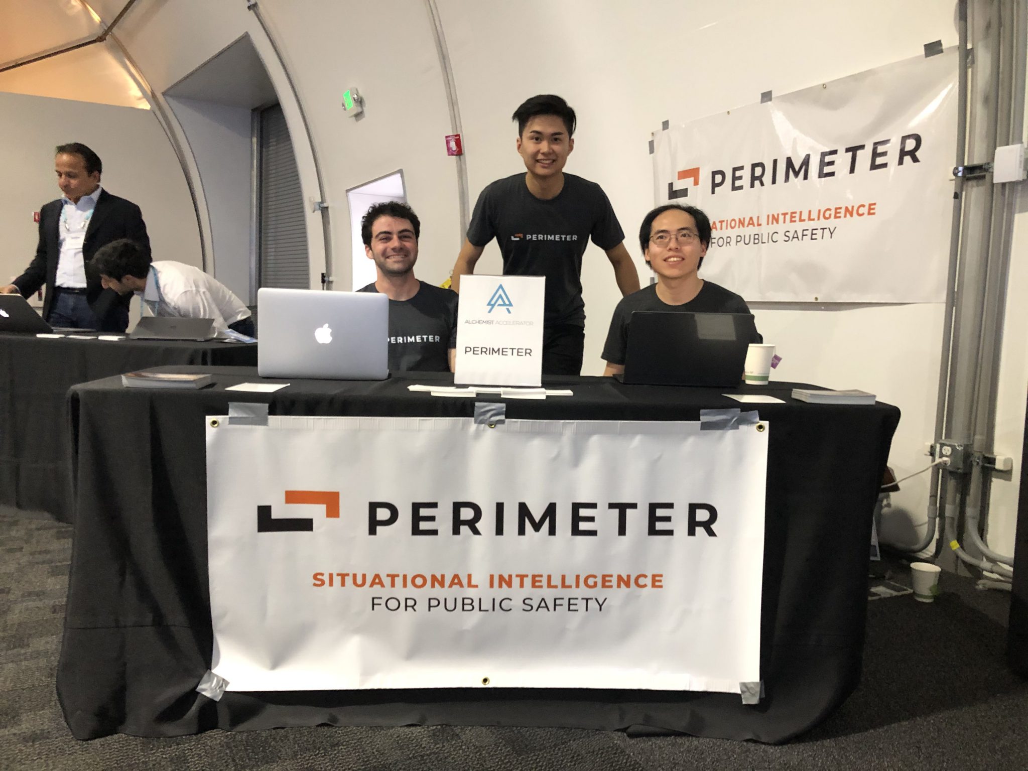 Co-founder and CTO Noah Wu oversees the Perimeter team's table at Demo Day, alongside team members Jacob Green and Moor Xu.