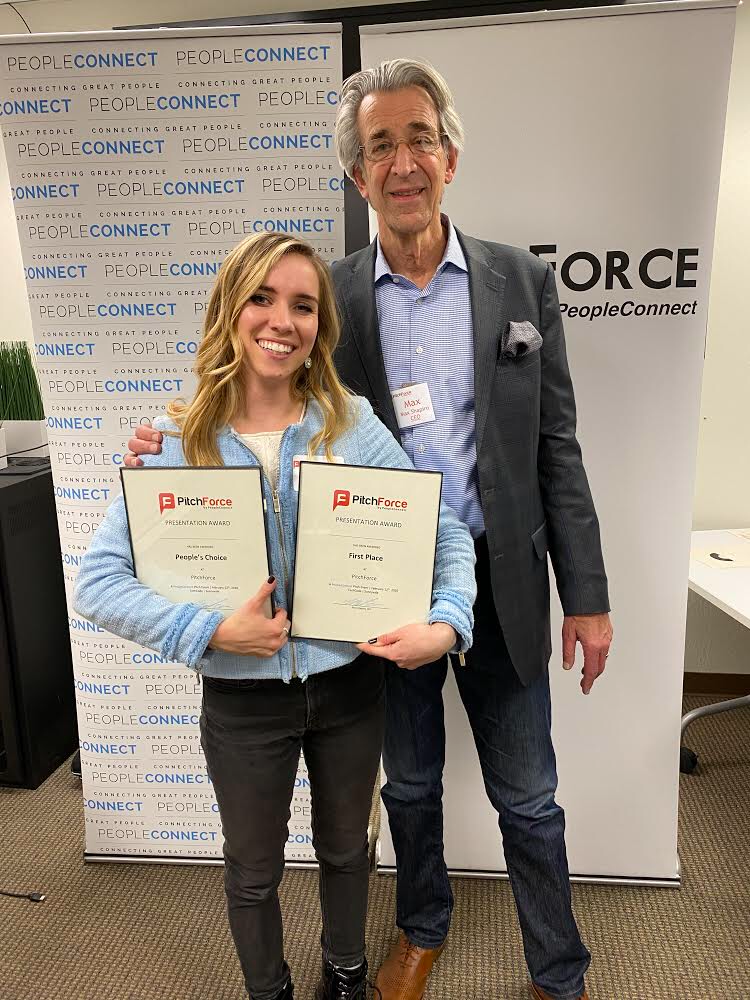 Farren holds her Best Pitch and People's Choice awards while standing with event producer and PeopleConnect CEO Max Shapiro.