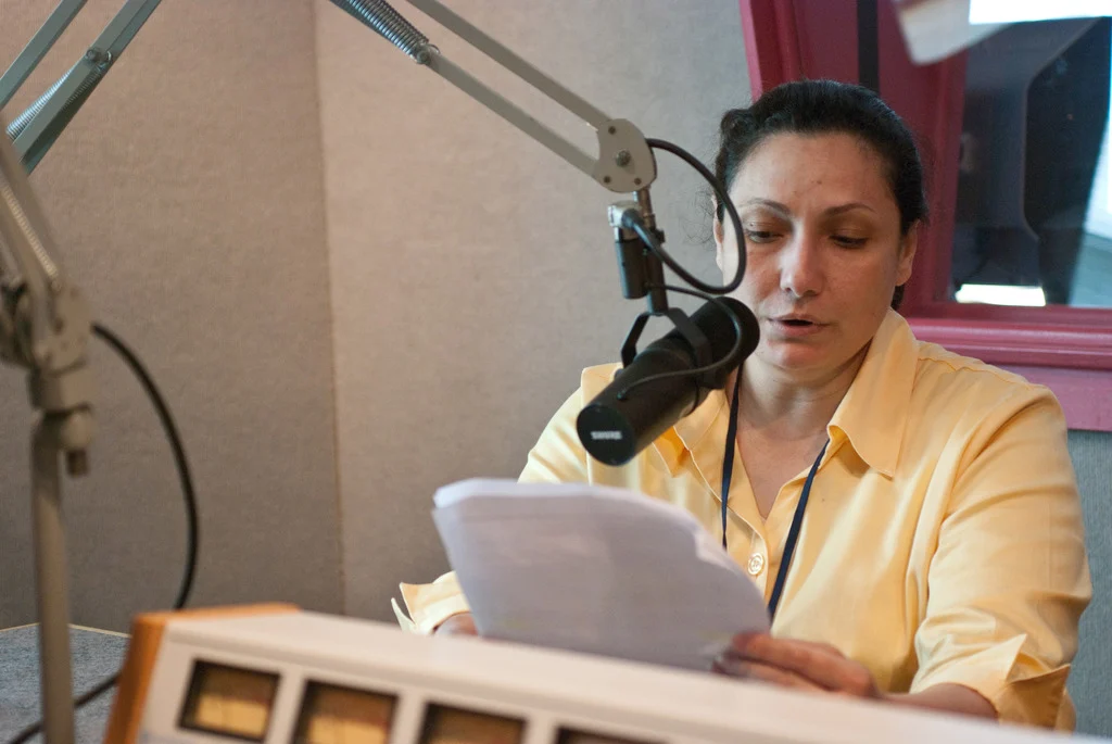 Flooding - Glassboro, N. J. , May 4, 2010 -- Individual Assistant specialist Sherin Nassar reads a FEMA public radio announcement in Arabic for the affected residents in New Jersey . FEMA