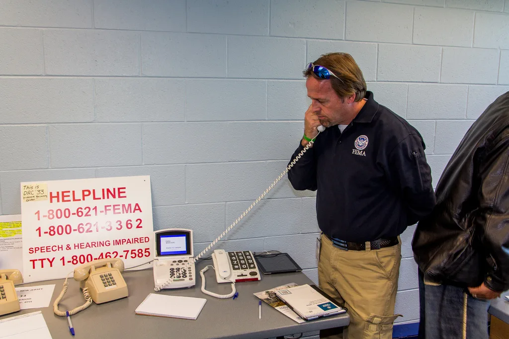 Mike Houston, FEMA Disability Integration Specialist, sets up the Video Remote Interpreting (VRI) kit at a Disaster Recovery Center (DRC) in New Jersey. FEMA offers the service to applicants with disabilities.